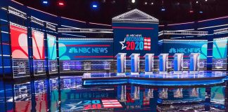 Fertility Quip Ignites Primetime Backlash Televised debate stage with multiple podiums and bright red, white, and blue lighting