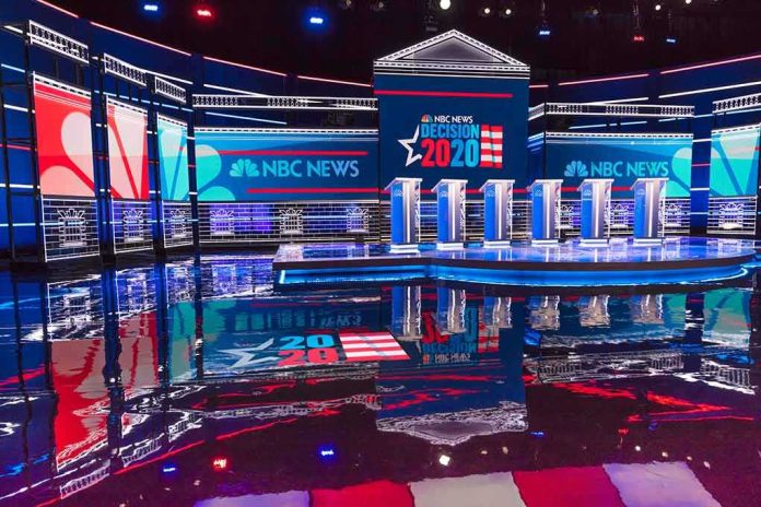 shutterstock_1656995710 Televised debate stage with multiple podiums and bright red, white, and blue lighting