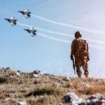 Jordan’s Air Force Shot Down 20 Iranian Missiles — Here’s What We Know Soldier standing on rocky hillside watching fighter jets fly overhead