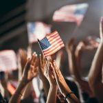 Pop Star Ditches Neutral – Crowd Gasps American flag waved by crowd