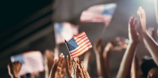 American flag waved by crowd