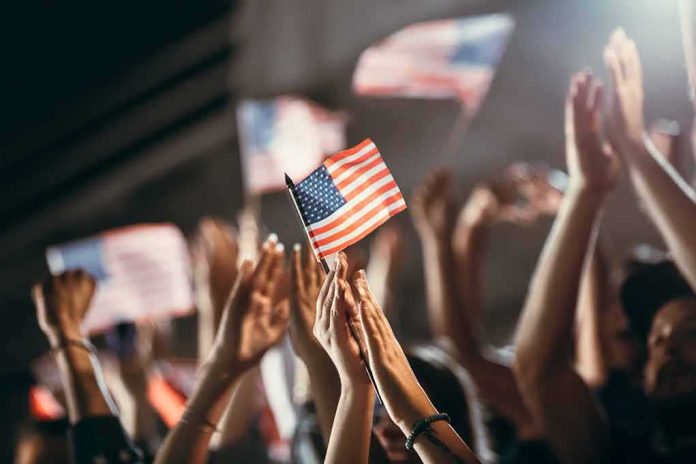 shutterstock_1718759467 American flag waved by crowd