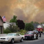 More Than 12,000 Fires Are Straining One Major City Emergency vehicles respond to wildfire near suburban homes