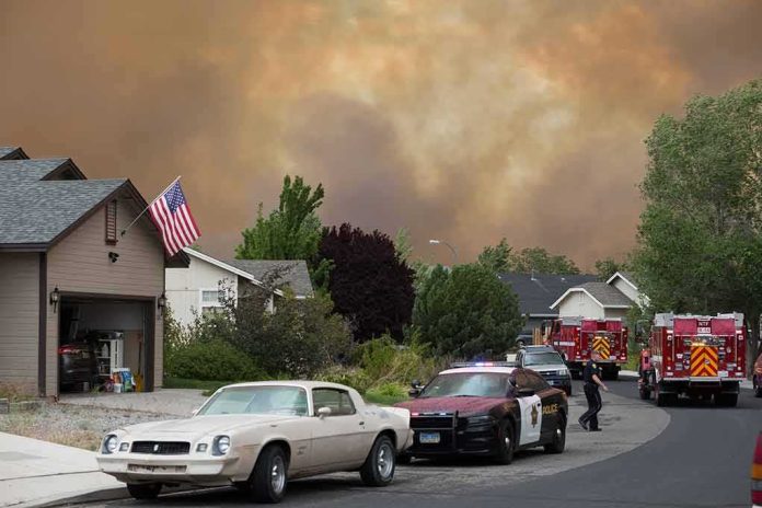 shutterstock_1772803076 Emergency vehicles respond to wildfire near suburban homes