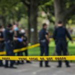 Sudden Ambush at Park — Rookie Officer Falls crime scene tape with police officers in a park