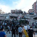 Once‑In‑A‑Century Disaster Unfolds Rescue workers and civilians on collapsed building after earthquake