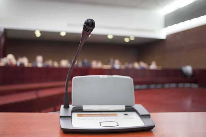 shutterstock_184839470 Microphone on a podium in a courtroom