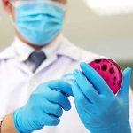 Jalapeño Salsas Flagged—Nationwide Salmonella Scare Scientist holding a petri dish with pink agar