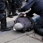 Bystanders Take Down Man Firing Arrows At Cars police detain person on sidewalk during street incident