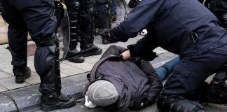 Bystanders Take Down Man Firing Arrows At Cars police detain person on sidewalk during street incident
