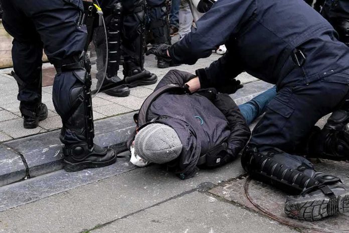 police detain person on sidewalk during street incident