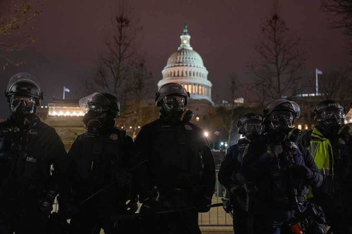 Riot police in protective gear stand before a domed capitol building at night