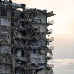 Man Jumps As Flames Spread – Arson Clues Emerge Partially collapsed apartment building with exposed rooms and debris