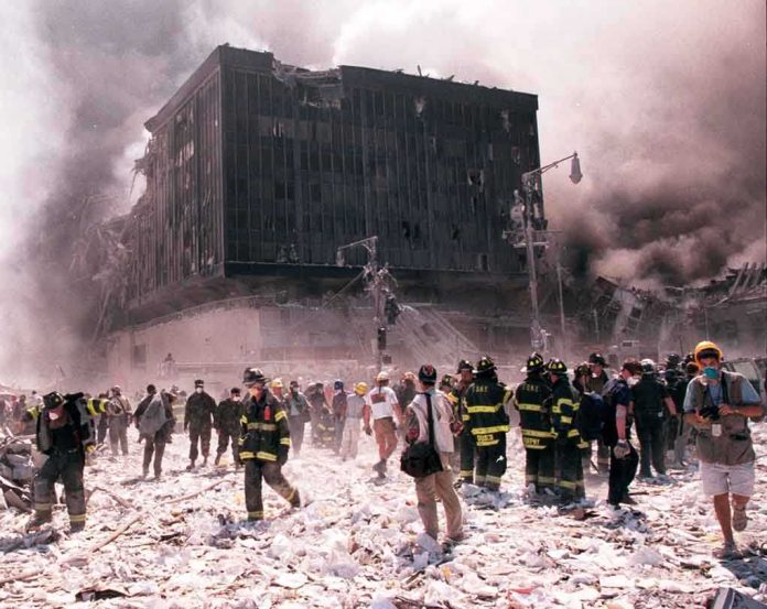 First responders amid debris near a heavily damaged building