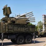 War Panic Trumps Buy-European Push military air defense vehicles on a road