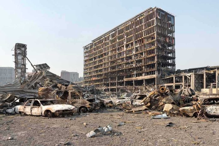 shutterstock_2140835365 Burned-out cars amid a gutted high-rise building