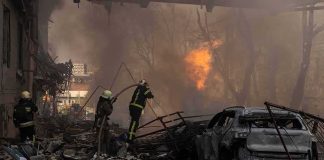 Flames Erupt Beside A Major International Airport Firefighters tackle blaze amid rubble and a burned car