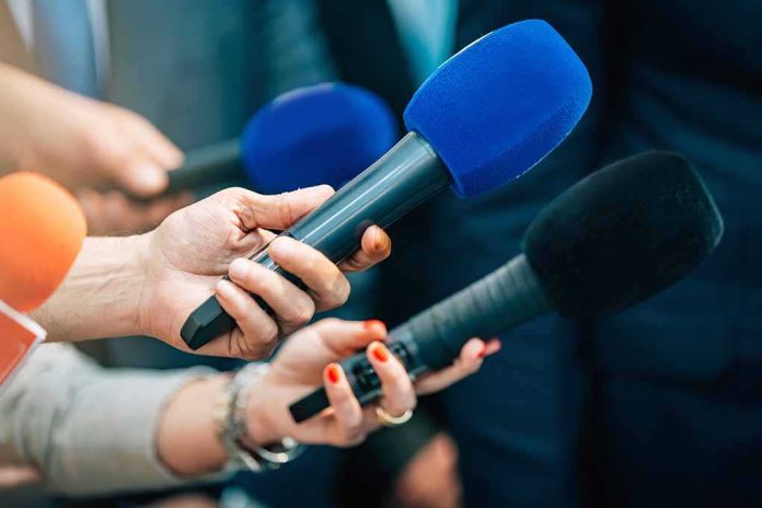 shutterstock_2168392339-2 Reporters holding colorful microphones