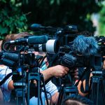 Patriotic Power Move Turbocharges Trucking TV news cameras crowding together at an outdoor event