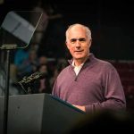 Bob P. Casey, Jr. speaking at a podium with microphones and teleprompter