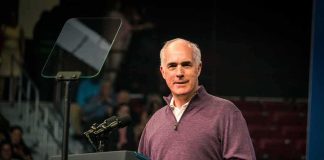 Bob P. Casey, Jr. speaking at a podium with microphones and teleprompter