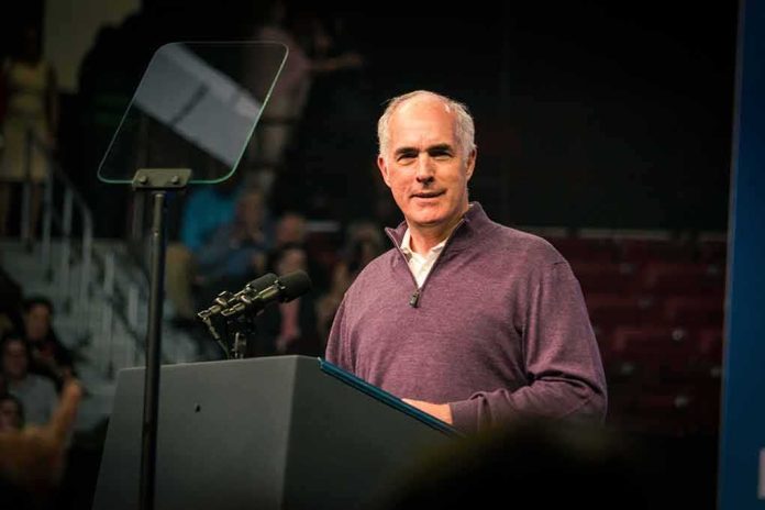 Bob P. Casey, Jr. speaking at a podium with microphones and teleprompter