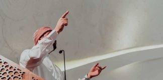 Mayor’s Holiday Bet Ignites Constitutional Clash Speaker in traditional attire gesturing from a carved wooden podium