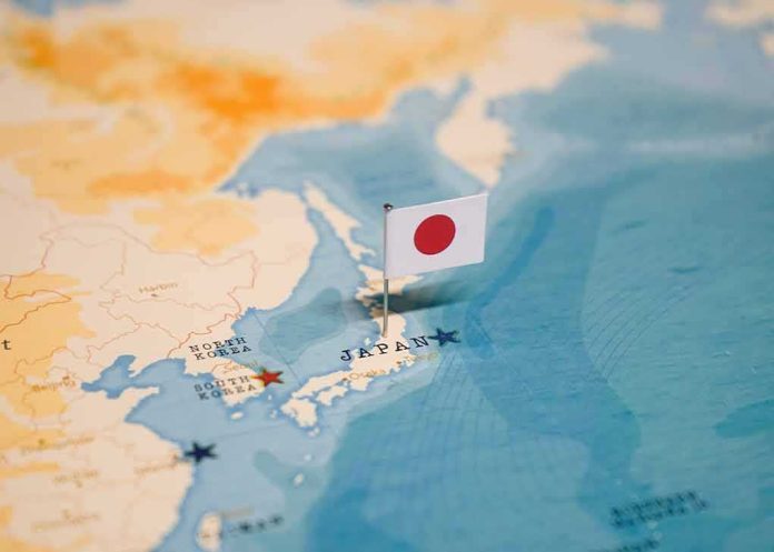 shutterstock_2327414549 Japanese flag pin marking Japan on a world map