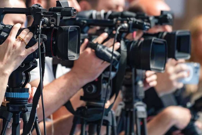 shutterstock_2692761619-1 television cameras on tripods at a media event