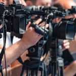 Corporate Welfare Runs Wild In Michigan television cameras on tripods at a media event