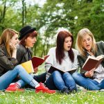 Upward’s Marriage Play Rattles Tinderland Group of young women reading books on grass in a park