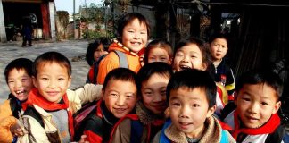 Group of smiling schoolchildren gathered outdoors