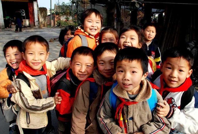 shutterstock_318245144 Group of smiling schoolchildren gathered outdoors
