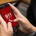 Robot On The Line In New Orleans Hands holding a smartphone with a 911 emergency call screen