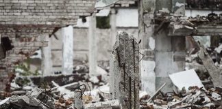 ruined concrete building with debris and exposed rebar