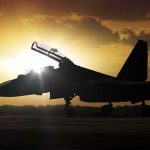 Iran Strikes Back—Lines Keep Blurring fighter jet on runway at sunset with open canopy