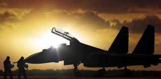 fighter jet on runway at sunset with open canopy