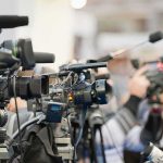 F— ICE Chant Hijacks Live TV Video cameras on tripods at a press event