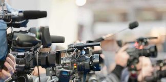 Video cameras on tripods at a press event