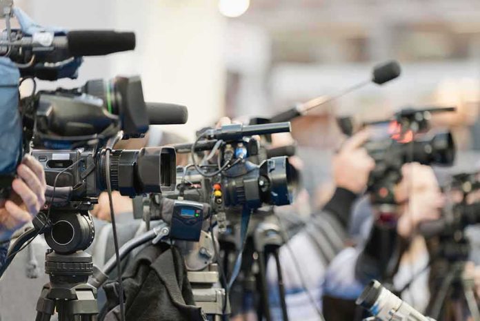 shutterstock_436152244 Video cameras on tripods at a press event