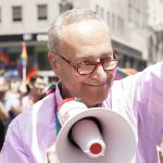 Family Crusade Sparks Nationwide Dragnet Smiling man with a megaphone at a pride parade