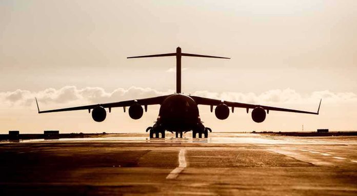 shutterstock_467492654 Large cargo aircraft on runway at sunrise