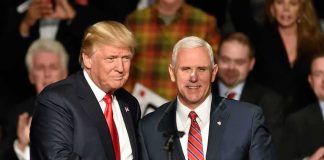 Donald Trump and Mike Pence shake hands on stage; Jeff Lord is in the background