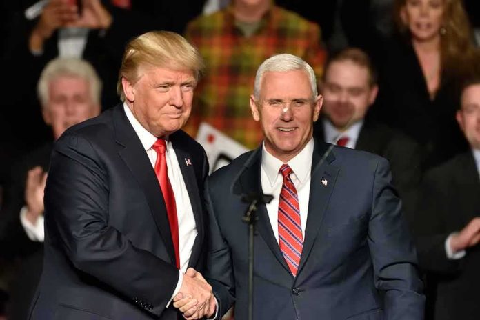shutterstock_538492738 Donald Trump and Mike Pence shake hands on stage; Jeff Lord is in the background