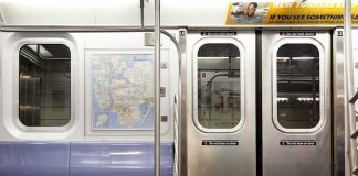 Subway car interior with stainless doors and empty blue bench