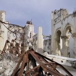Holy Icon Ablaze After Massive Barrage Interior view of a destroyed building with collapsed arches and debris