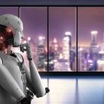 Humanoid robot thinking by window overlooking blurred city skyline