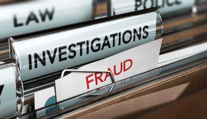 shutterstock_672511930 File folders labeled investigations and fraud in a filing cabinet
