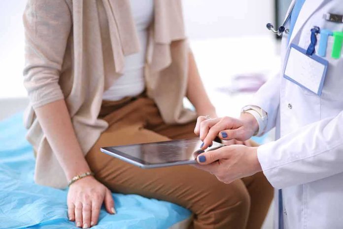shutterstock_694995316 doctor showing patient information on a tablet