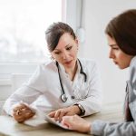 Medicaid Billing Bomb Ticks In Texas Doctor consulting a patient at a desk